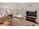Spacious living area flowing into dining and kitchen, featuring plush carpet and a ceiling fan at 5445 E Mckellips Rd # 23, Mesa, AZ 85215