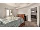 Spacious bedroom features a large window, ceiling fan, wood dresser, and a view into the living room at 5445 E Mckellips Rd # 23, Mesa, AZ 85215