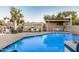 Community pool area featuring a refreshing pool, lounge chairs, and covered seating area at 5445 E Mckellips Rd # 23, Mesa, AZ 85215