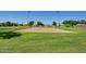 Community sand volleyball court surrounded by grassy areas and mature trees at 5445 E Mckellips Rd # 23, Mesa, AZ 85215