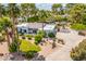 Aerial view of the home with lush landscaping, pool, desert plants, and circle drive at 6112 E Jenan Dr, Scottsdale, AZ 85254