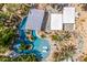 Aerial view of a home with a uniquely designed pool and lush landscaping at 6112 E Jenan Dr, Scottsdale, AZ 85254