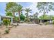 Spacious backyard with lush palm trees, rock features, gravel landscaping and modern design at 6112 E Jenan Dr, Scottsdale, AZ 85254