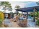 Resort-style backyard featuring a gorgeous pool, rock features, shaded pergola, and desert landscaping at 6112 E Jenan Dr, Scottsdale, AZ 85254