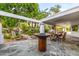 Charming backyard featuring stone patio with dining and landscaped gardens with a water feature at 6112 E Jenan Dr, Scottsdale, AZ 85254