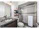 Updated bathroom featuring vanity, modern toilet, vanity storage, and shower with glass door at 6112 E Jenan Dr, Scottsdale, AZ 85254