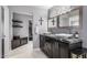 Bathroom features a vanity with dual sinks, granite countertop, and a walk-in closet at 6112 E Jenan Dr, Scottsdale, AZ 85254