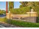 Equestrian Manor community entrance with well-manicured landscaping and attractive signage at 6112 E Jenan Dr, Scottsdale, AZ 85254