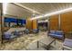 Inviting covered patio featuring comfortable seating, stone floors, modern lighting, and wood paneling at 6112 E Jenan Dr, Scottsdale, AZ 85254