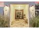 Elegant entryway with double doors, stylish lighting, and tiled floor create a welcoming ambiance at 6112 E Jenan Dr, Scottsdale, AZ 85254