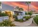 Charming courtyard entrance with wrought iron gate and lush desert landscaping at 6112 E Jenan Dr, Scottsdale, AZ 85254