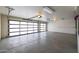 Clean and organized garage interior featuring glass doors, smooth flooring, and ample space at 6112 E Jenan Dr, Scottsdale, AZ 85254