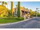 Community guard house with stone driveway, mature landscaping, and gated entry at 6112 E Jenan Dr, Scottsdale, AZ 85254