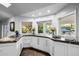 Bright kitchen area featuring granite countertops, a sink, and views of the backyard at 6112 E Jenan Dr, Scottsdale, AZ 85254