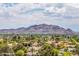 Picturesque neighborhood view featuring charming homes nestled among mature trees with mountain views in the distance at 6112 E Jenan Dr, Scottsdale, AZ 85254