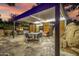 Outdoor entertaining area featuring a covered kitchen, dining area, stone patio, and desert landscaping at 6112 E Jenan Dr, Scottsdale, AZ 85254