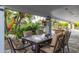 Outdoor dining area on covered patio, framed by lush landscaping and outdoor decorations at 6112 E Jenan Dr, Scottsdale, AZ 85254