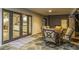 Inviting covered patio with stone floors, dining set, and easy access to the indoors at 6112 E Jenan Dr, Scottsdale, AZ 85254