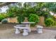 Community picnic area with shade trees, lush landscaping, and concrete table at 6112 E Jenan Dr, Scottsdale, AZ 85254