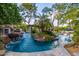 Outdoor pool area showcases lush landscaping, a rock waterfall, and in-pool seating at 6112 E Jenan Dr, Scottsdale, AZ 85254