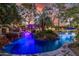 Spectacular outdoor pool area with waterfall, lush landscaping, and private cabana at 6112 E Jenan Dr, Scottsdale, AZ 85254