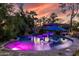Resort-style pool with waterfalls, lounge chairs, and lush tropical landscaping at 6112 E Jenan Dr, Scottsdale, AZ 85254