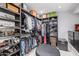 Organized walk-in closet features custom shelving, racks, and a central ottoman at 6112 E Jenan Dr, Scottsdale, AZ 85254