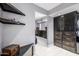 Walk-in closet with custom dark wood shelving and drawers for optimal storage at 6112 E Jenan Dr, Scottsdale, AZ 85254