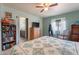 Comfortable bedroom featuring a ceiling fan, natural light and tile flooring at 6311 E Ivy St, Mesa, AZ 85205