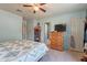Charming bedroom boasts tile floors, ceiling fan, and calming pastel walls at 6311 E Ivy St, Mesa, AZ 85205