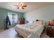 Inviting bedroom with ceiling fan, natural light, and neutral-toned decor at 6311 E Ivy St, Mesa, AZ 85205