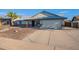Inviting single-story home with a well-maintained front yard and a spacious driveway leading to a two-car garage at 6311 E Ivy St, Mesa, AZ 85205