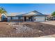 Attractive single-level home with a manicured front yard, convenient two-car garage, and charming curb appeal at 6311 E Ivy St, Mesa, AZ 85205