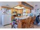 Functional kitchen featuring breakfast bar and wooden cabinetry at 6311 E Ivy St, Mesa, AZ 85205