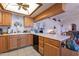 Kitchen featuring natural wood cabinetry, white countertops, and tile flooring at 6311 E Ivy St, Mesa, AZ 85205