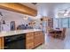 Kitchen with island that opens to dining and Gathering room for easy entertaining at 6311 E Ivy St, Mesa, AZ 85205