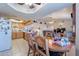 Spacious kitchen with wooden dining table offering seamless access to multiple rooms in the house at 6311 E Ivy St, Mesa, AZ 85205