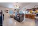Open-concept living area with tile floors and a partial view into the kitchen, featuring cozy furniture at 6311 E Ivy St, Mesa, AZ 85205
