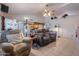 Inviting living room featuring cozy seating, neutral color palette, and seamless flow to kitchen with bright natural light at 6311 E Ivy St, Mesa, AZ 85205