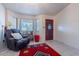 Bright living room featuring a bay window, tile flooring, a comfortable recliner, and a stylish accent rug at 6311 E Ivy St, Mesa, AZ 85205