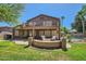 Large backyard featuring a multi-level patio with a firepit and lush landscaping, and pool at 6350 S Four Peaks Pl, Chandler, AZ 85249