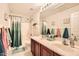 Bright bathroom features double sinks, updated fixtures, a shower-tub combination and colorful accents at 6350 S Four Peaks Pl, Chandler, AZ 85249