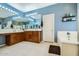 Bright bathroom with dual vanities, a soaking tub, and blue walls at 6350 S Four Peaks Pl, Chandler, AZ 85249