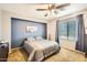 Comfortable bedroom with a blue accent wall and neutral decor at 6350 S Four Peaks Pl, Chandler, AZ 85249