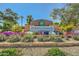 Community sign for Springfield Lakes with colorful flowers and beautiful landscaping at 6350 S Four Peaks Pl, Chandler, AZ 85249