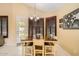 Cozy dining area featuring a wooden table, tiled floors, and stylish window shutters at 6350 S Four Peaks Pl, Chandler, AZ 85249