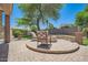 Backyard patio features a charming paver firepit area, perfect for outdoor gatherings at 6350 S Four Peaks Pl, Chandler, AZ 85249
