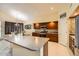 Modern kitchen featuring dark cabinetry, stainless steel appliances, and an island at 6350 S Four Peaks Pl, Chandler, AZ 85249