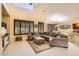 Open-concept living area with tile flooring, a cozy sectional sofa, and expansive windows at 6350 S Four Peaks Pl, Chandler, AZ 85249