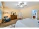 Spacious main bedroom with a blue armchair, dresser, and ensuite bathroom entrance at 6350 S Four Peaks Pl, Chandler, AZ 85249